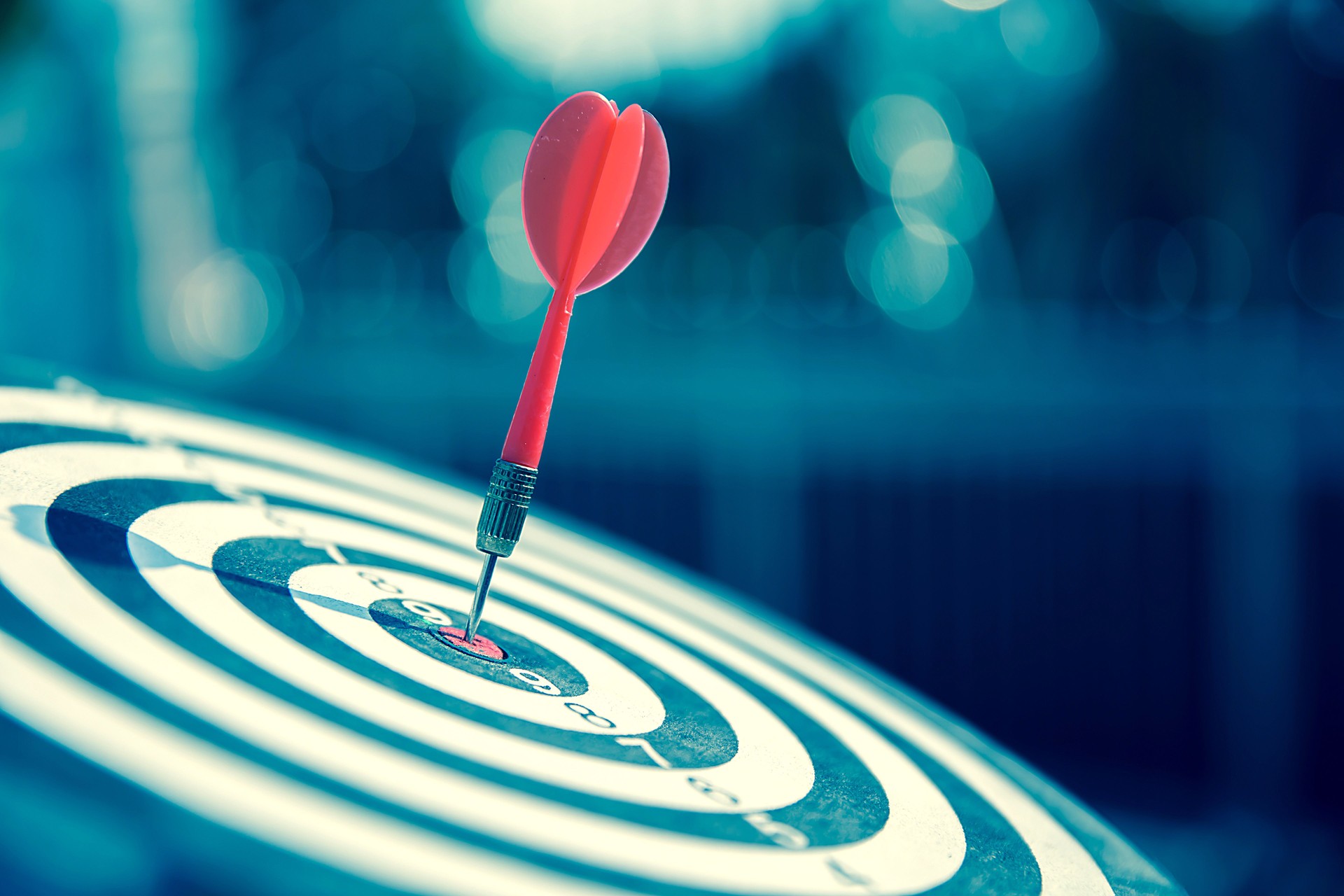 Bullseye or Bulls eye target or dartboard has dart arrow throw hitting the center of a shooting for financial business targeting planning and aim to winner goal of business concept. Bullseye or Bulls eye target or dartboard has dart arrow throw hitting the center of a shooting for financial business targeting planning and aim to winner goal of business concept.